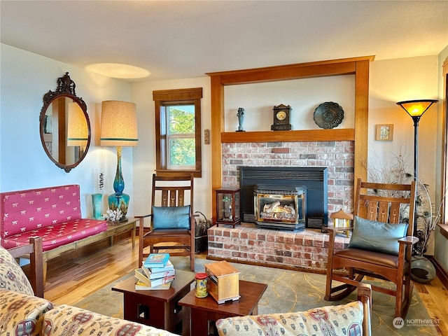 living area featuring wood finished floors and a fireplace