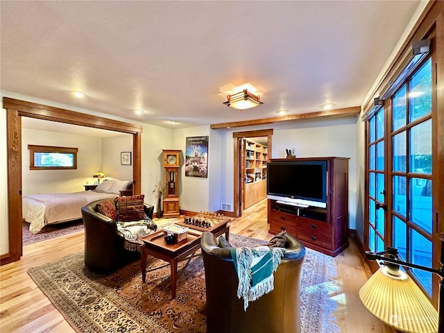 living room with visible vents, baseboards, and light wood-style floors