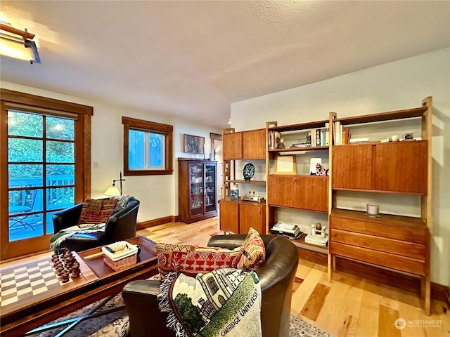 interior space with light wood-style floors and baseboards