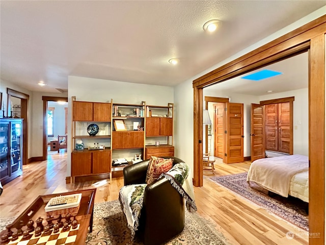 interior space with light wood-type flooring and a textured ceiling