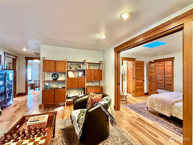 living room with light wood finished floors and baseboards