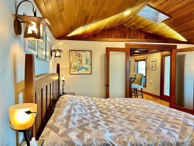 bedroom featuring vaulted ceiling with skylight and wooden ceiling