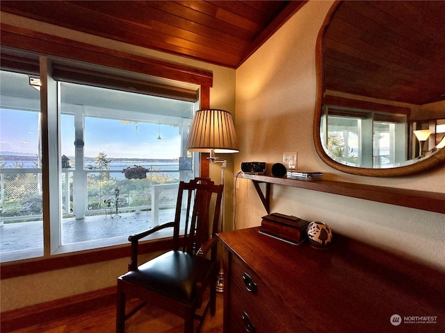 interior space with wood ceiling, wood finished floors, baseboards, and lofted ceiling