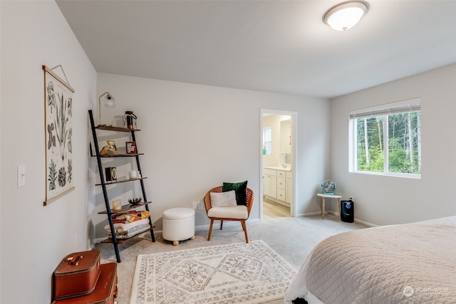 carpeted bedroom featuring connected bathroom