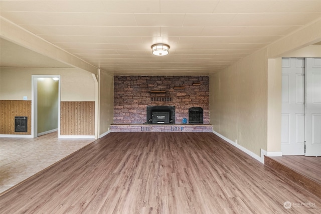 unfurnished living room featuring a fireplace and hardwood / wood-style flooring