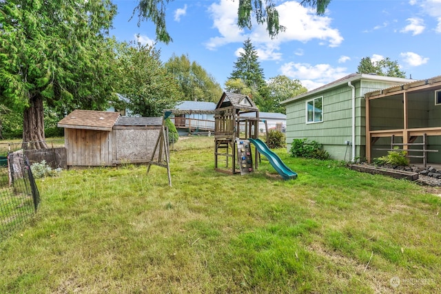 view of yard featuring a playground and an outbuilding