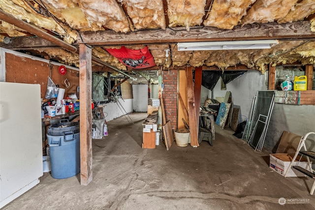 basement with white refrigerator