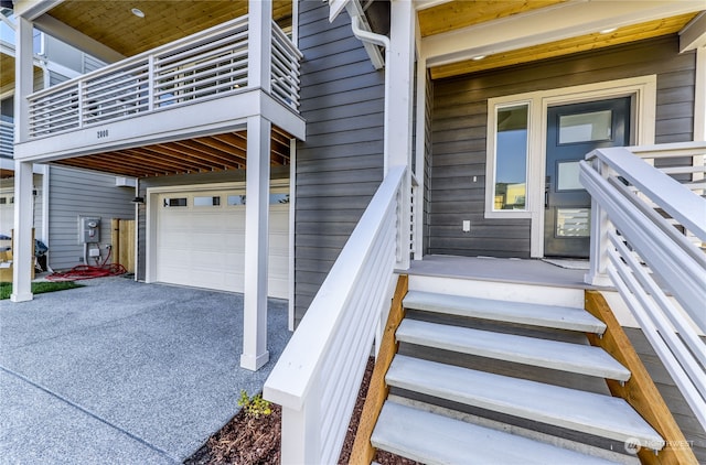 doorway to property featuring a balcony and a garage