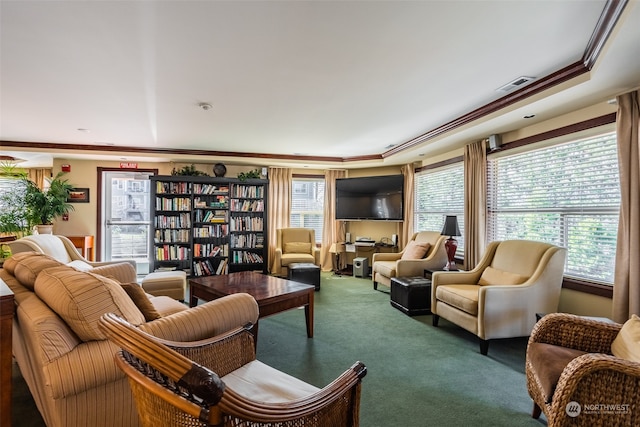 living room featuring dark carpet, crown molding, and a wealth of natural light