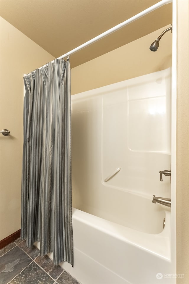 bathroom with shower / tub combo with curtain