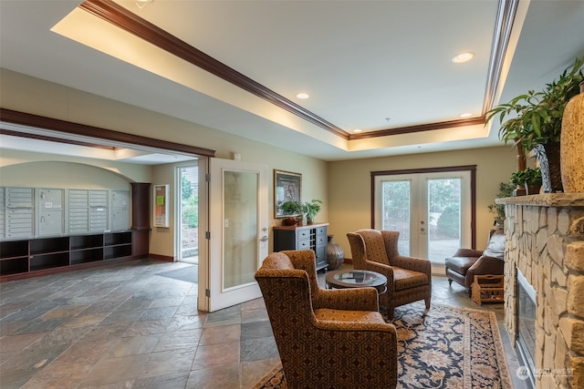 sitting room with french doors, a raised ceiling, crown molding, and a mail area