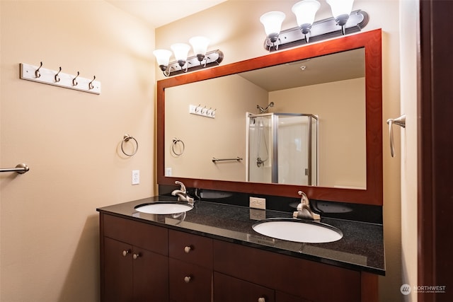 bathroom featuring walk in shower and vanity