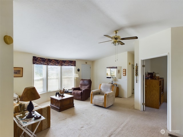 living room featuring ceiling fan, a textured ceiling, lofted ceiling, and light carpet