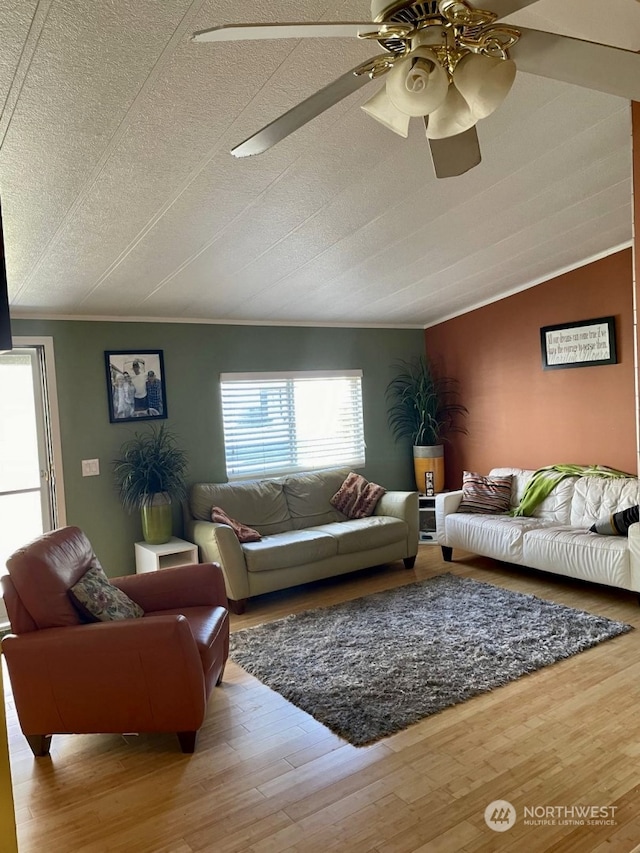 living room featuring a textured ceiling, crown molding, ceiling fan, and light hardwood / wood-style flooring