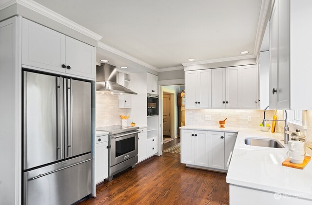 1406 Mcgilvra Blvd E, Seattle, WA 98112 - kitchen with sink, wall chimney exhaust hood, white cabinetry, appliances with stainless steel finishes, and dark hardwood / wood-style flooring