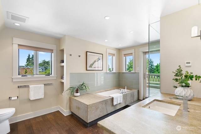1406 Mcgilvra Blvd E, Seattle, WA 98112 - bathroom featuring decorative backsplash, a tub to relax in, hardwood / wood-style flooring, and toilet