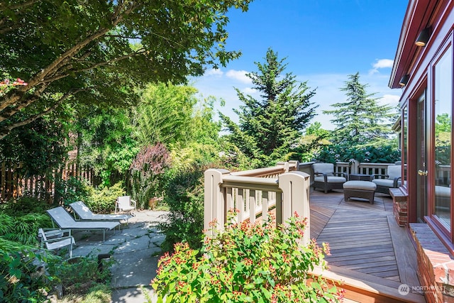 wooden deck featuring a patio and an outdoor hangout area