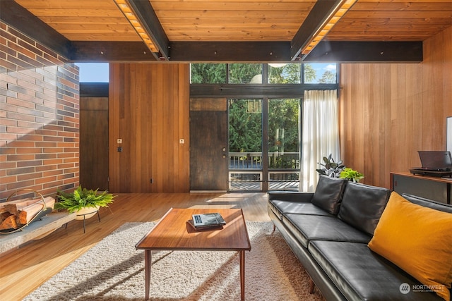 living room featuring wood walls, beamed ceiling, wooden ceiling, and hardwood / wood-style floors