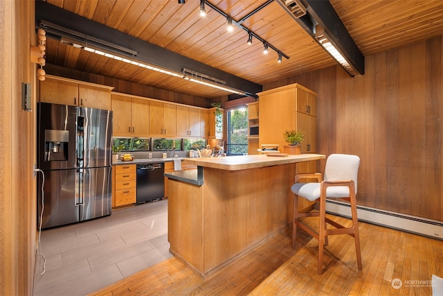 kitchen with a baseboard heating unit, light wood-type flooring, dishwasher, a kitchen island, and stainless steel fridge