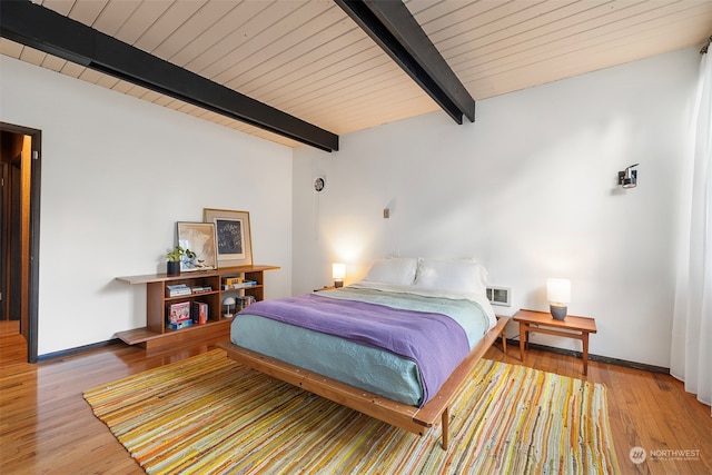 bedroom with wood ceiling, light hardwood / wood-style floors, and beam ceiling