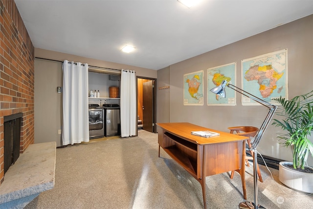 home office with washing machine and dryer and a fireplace