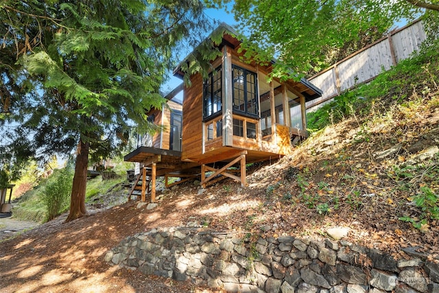 view of home's exterior with a sunroom