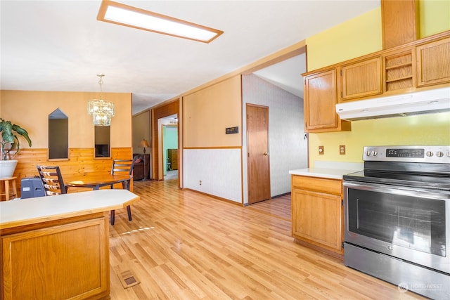 kitchen featuring pendant lighting, vaulted ceiling, an inviting chandelier, stainless steel electric range oven, and light hardwood / wood-style floors