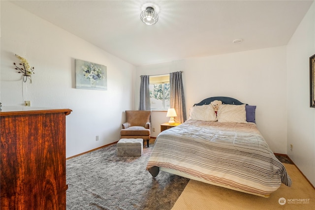 bedroom featuring carpet and lofted ceiling