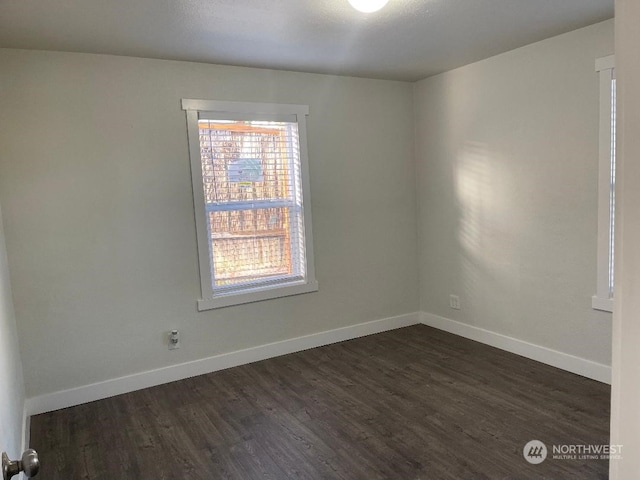 unfurnished room featuring dark hardwood / wood-style floors