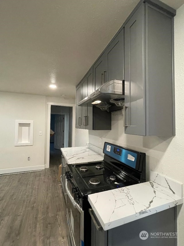 kitchen with light stone countertops, gray cabinets, ventilation hood, black range, and dark hardwood / wood-style floors