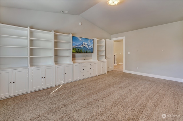 unfurnished living room with light carpet and vaulted ceiling