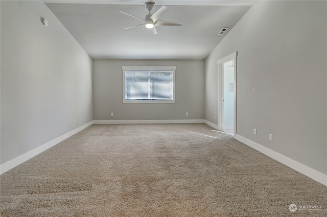 carpeted empty room featuring lofted ceiling and ceiling fan