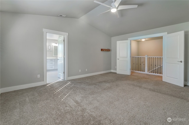 spare room with ceiling fan, lofted ceiling, and carpet