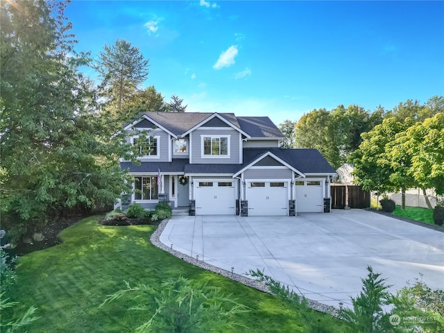 view of front of home with a front yard and a garage