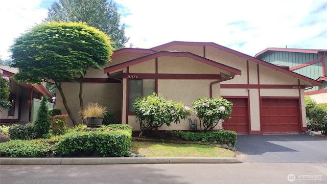 31717 48th Ln SW Unit A, Federal Way, WA 98023 - view of front facade with an attached garage, asphalt driveway, and stucco siding