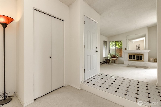 31717 48th Ln SW Unit A, Federal Way, WA 98023 - foyer entrance with carpet floors, a baseboard radiator, tile patterned floors, lofted ceiling, and a fireplace