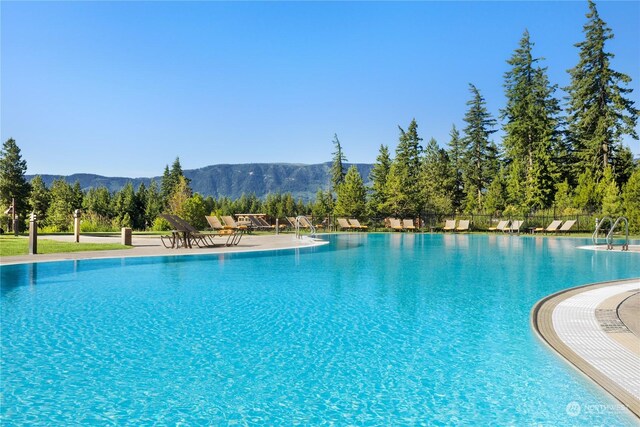 view of swimming pool with a mountain view