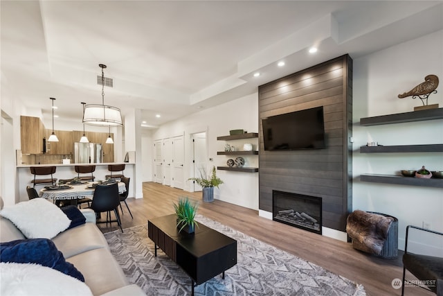 living room featuring hardwood / wood-style flooring and a fireplace