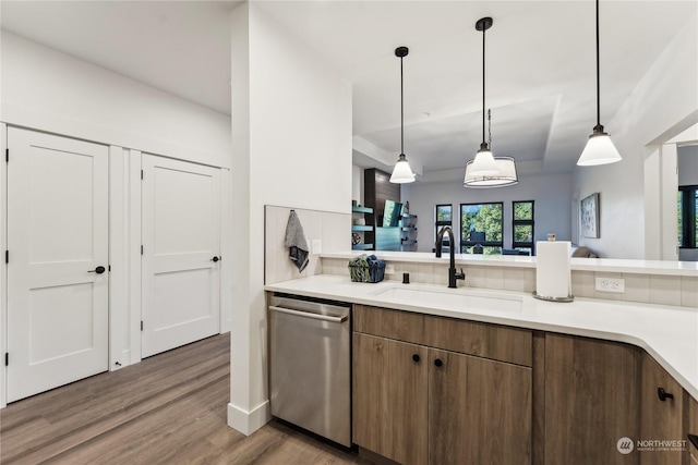 3760 Suncadia Trl Unit 313, Cle Elum, WA 98922 - kitchen with wood finished floors, dishwasher, light countertops, a sink, and hanging light fixtures