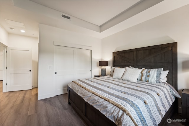 bedroom featuring hardwood / wood-style flooring and a closet