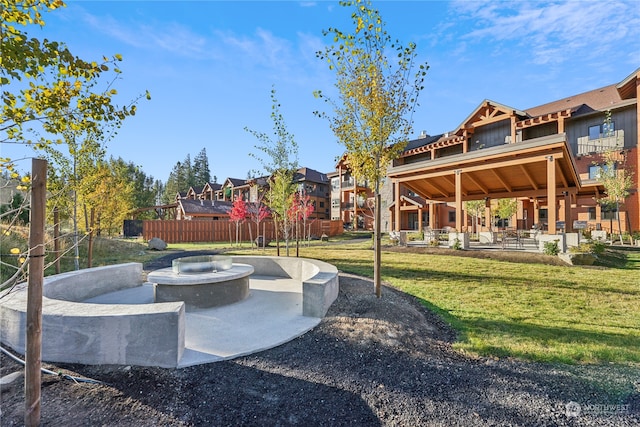 view of community with a yard and a patio area