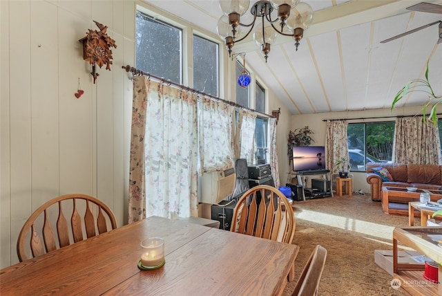 dining area featuring carpet flooring, lofted ceiling with beams, and a chandelier