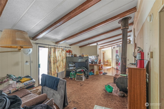 interior space featuring a textured ceiling, wooden walls, and carpet floors