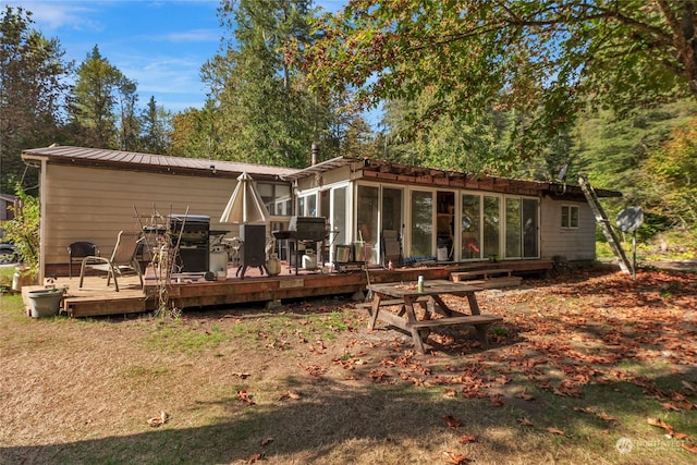 back of property featuring a wooden deck