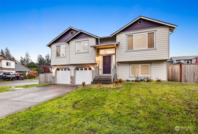 split foyer home featuring a garage and a front yard