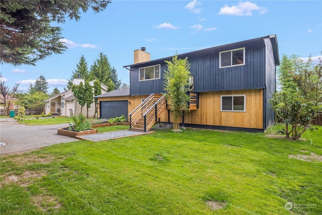 view of front of home featuring a garage and a front yard