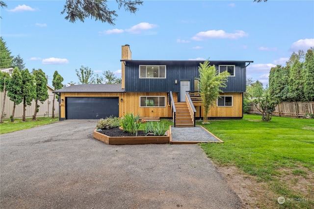 view of front facade with a garage and a front lawn