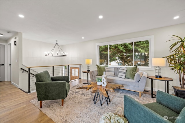 living room featuring light hardwood / wood-style floors and a notable chandelier