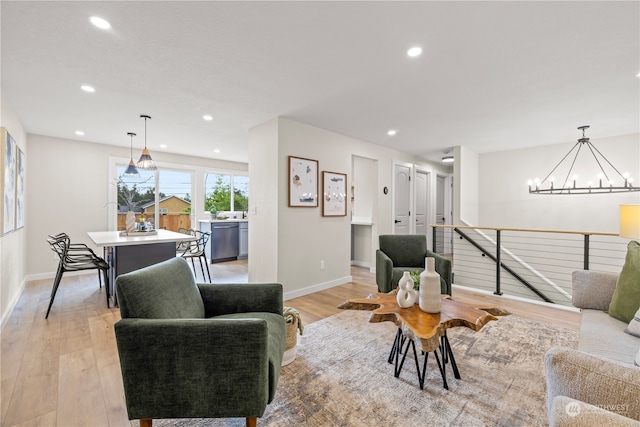 living room featuring light hardwood / wood-style flooring and a chandelier