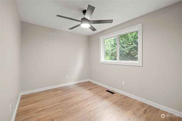 spare room with ceiling fan and light wood-type flooring